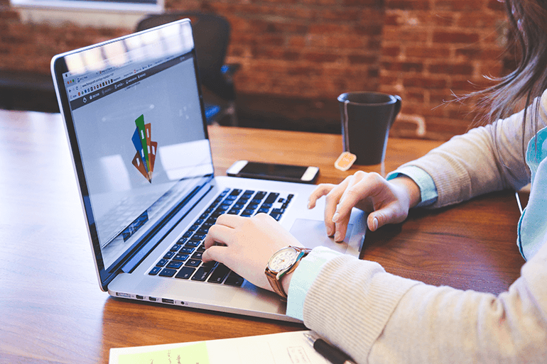 A woman running her web hosting reseller business on a laptop