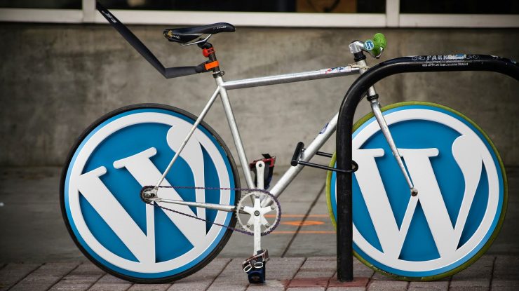 WordPress staging represented by two WordPress logos on cycle wheels